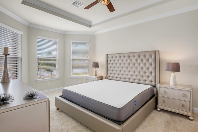 carpeted bedroom with crown molding, a raised ceiling, and ceiling fan