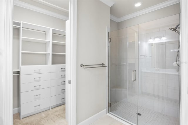 bathroom featuring ornamental molding and a shower with shower door