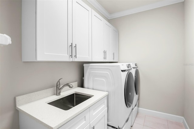 washroom featuring light tile patterned flooring, sink, cabinets, ornamental molding, and independent washer and dryer