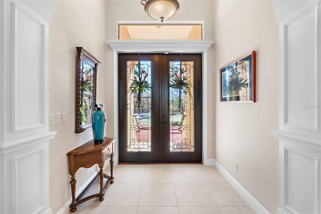 entrance foyer featuring french doors and light tile patterned floors