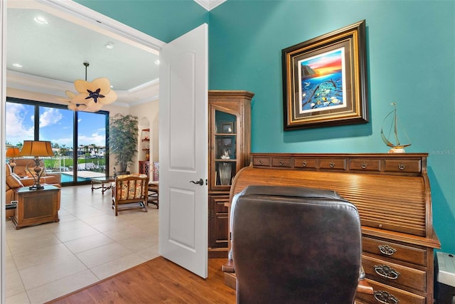 office area featuring an inviting chandelier, ornamental molding, and light hardwood / wood-style floors