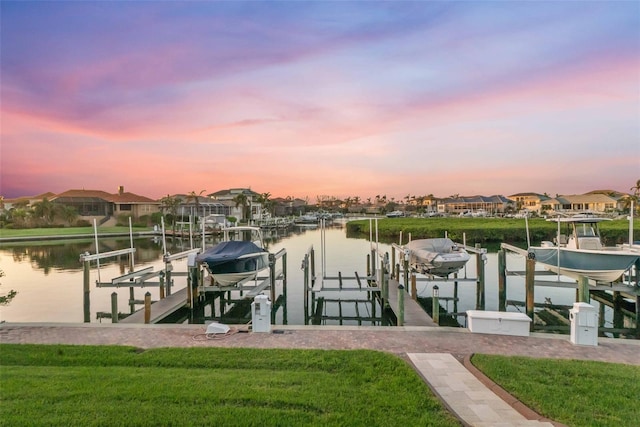 dock area with a yard and a water view