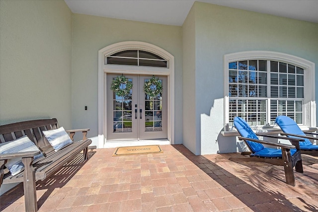 property entrance with a patio and french doors