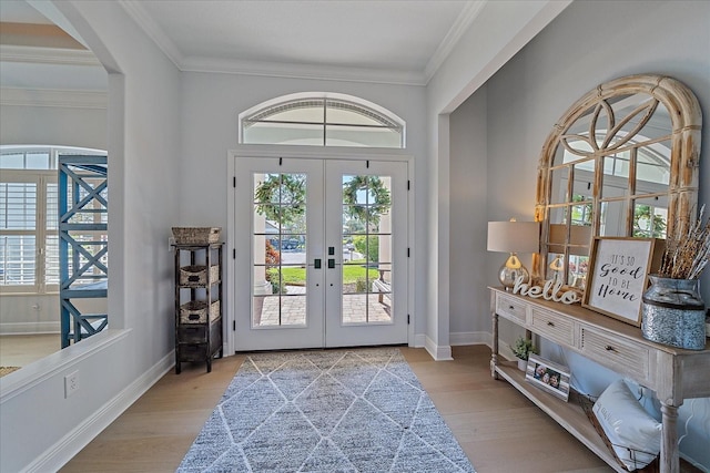 doorway to outside featuring ornamental molding, french doors, and light wood-type flooring