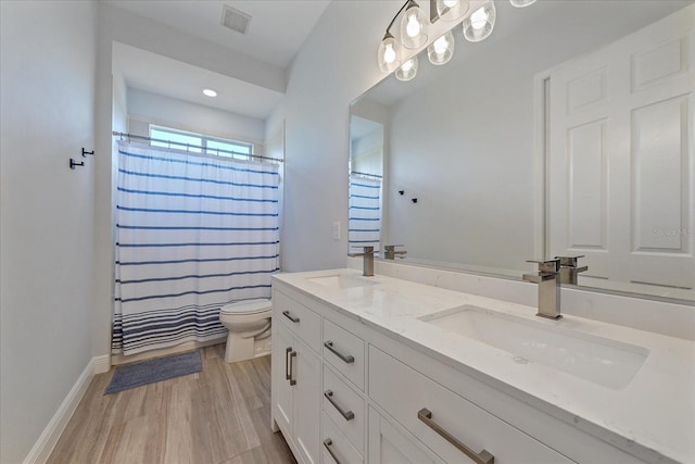 bathroom with vanity, wood-type flooring, a shower with shower curtain, and toilet