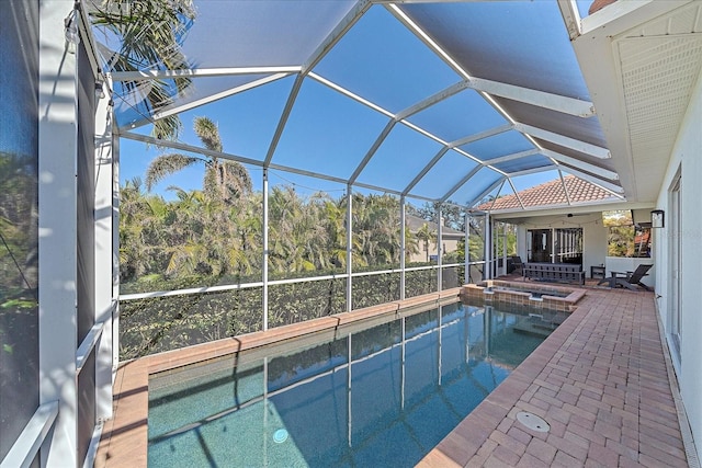 view of pool with ceiling fan, a lanai, and a patio area