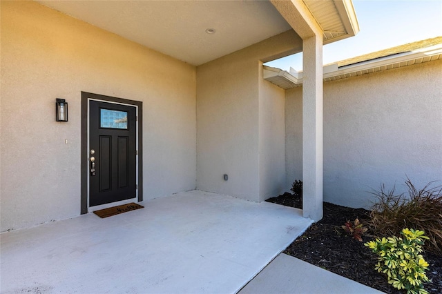 doorway to property featuring a patio area