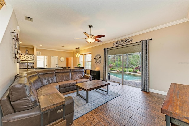 living room featuring hardwood / wood-style floors, ornamental molding, and ceiling fan