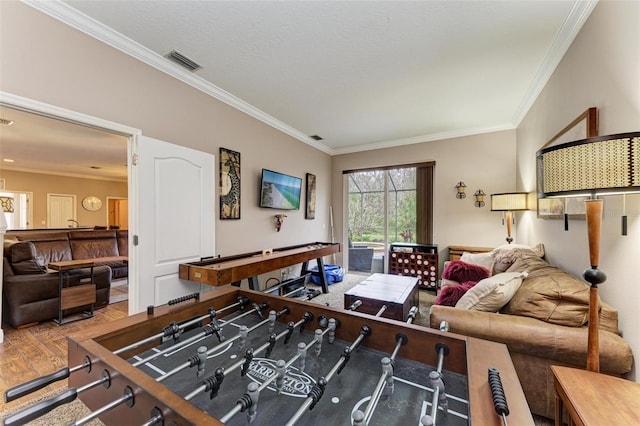 recreation room featuring hardwood / wood-style flooring and ornamental molding