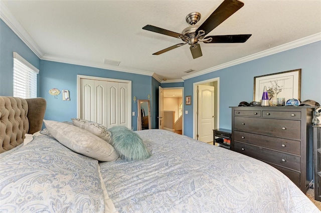 bedroom with ceiling fan, ornamental molding, and a closet