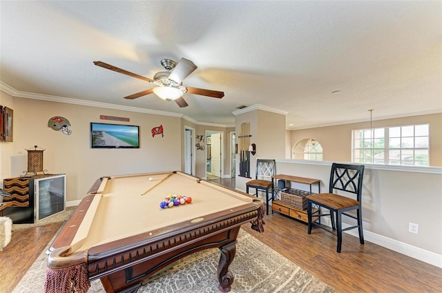 game room featuring wood-type flooring, ornamental molding, pool table, and a textured ceiling