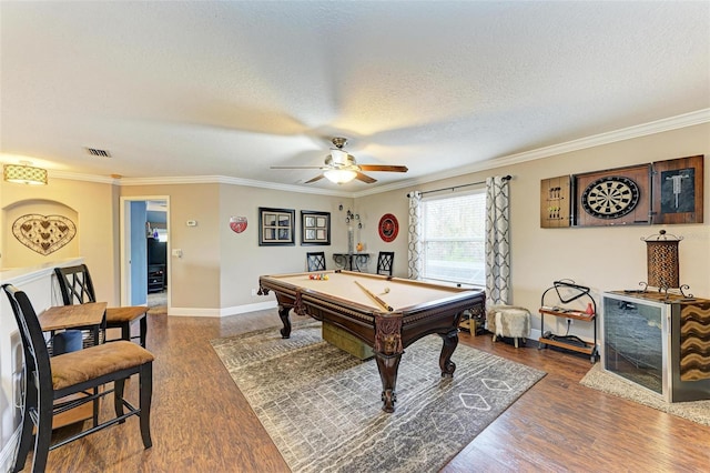 rec room with crown molding, dark wood-type flooring, a textured ceiling, and billiards