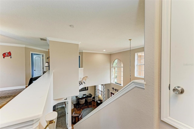 staircase featuring crown molding and a textured ceiling