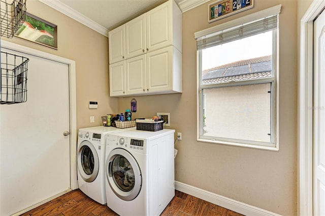 laundry room featuring cabinets, washing machine and dryer, ornamental molding, and dark wood-type flooring