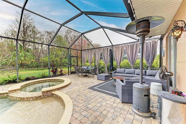 view of patio / terrace with a lanai, outdoor lounge area, and an in ground hot tub