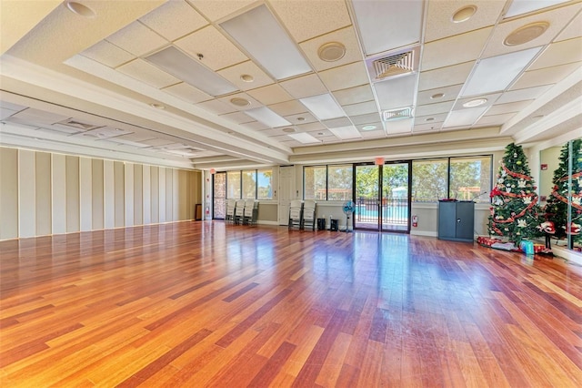 223 Heritage Isles Way, Bradenton, FL 34212 - workout room featuring a healthy amount of sunlight, wallpapered walls, wood finished floors, and visible vents
