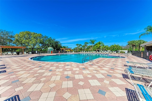 223 Heritage Isles Way, Bradenton, FL 34212 - community pool featuring a patio and fence