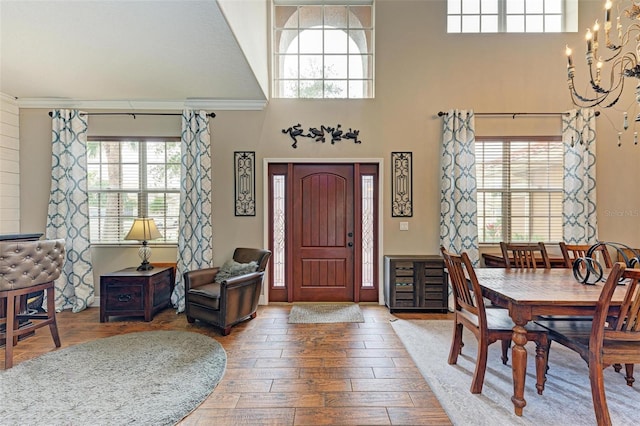 223 Heritage Isles Way, Bradenton, FL 34212 - foyer featuring an inviting chandelier, a towering ceiling, and wood finished floors