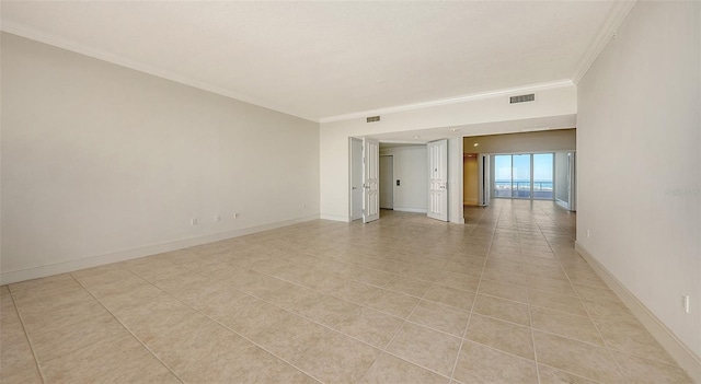 unfurnished room featuring light tile patterned floors and ornamental molding