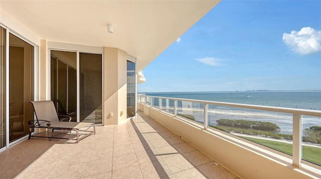 balcony featuring a water view and a view of the beach