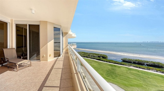 balcony featuring a water view and a view of the beach