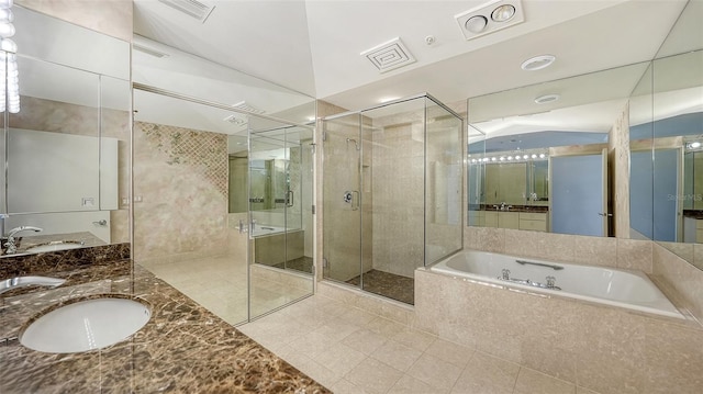 bathroom featuring vanity, plus walk in shower, and tile patterned flooring