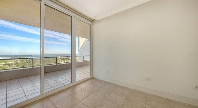 unfurnished room with light tile patterned flooring and ornamental molding