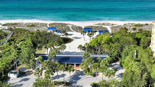 drone / aerial view featuring a water view and a beach view