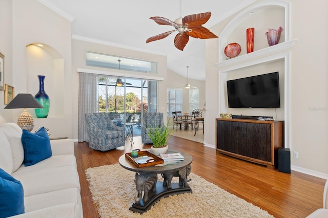 living room featuring hardwood / wood-style flooring, ornamental molding, and ceiling fan