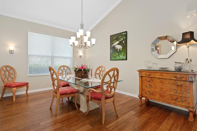 dining area with ornamental molding, lofted ceiling, an inviting chandelier, and dark hardwood / wood-style flooring