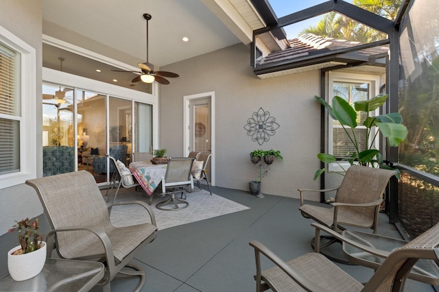 sunroom with ceiling fan and plenty of natural light