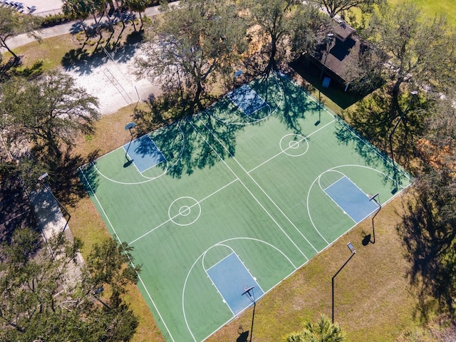 view of basketball court with a lawn