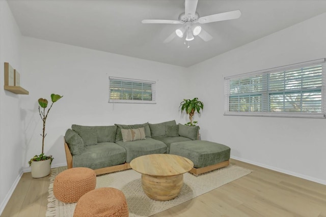 living room featuring light hardwood / wood-style flooring and ceiling fan