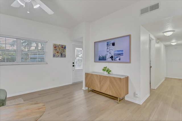 foyer with ceiling fan and light hardwood / wood-style flooring