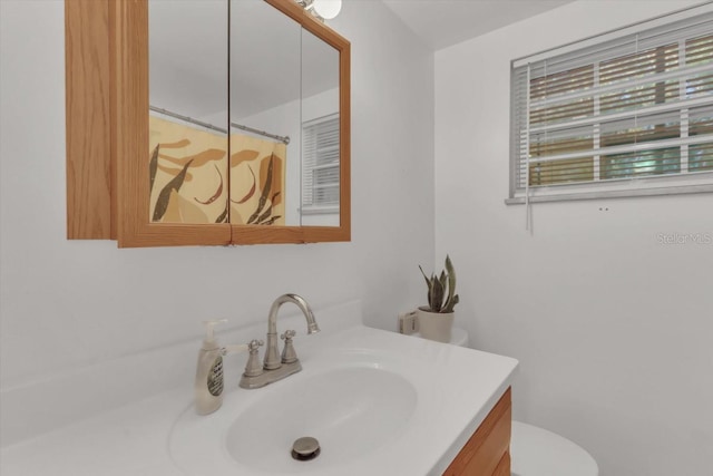 bathroom with vanity and toilet