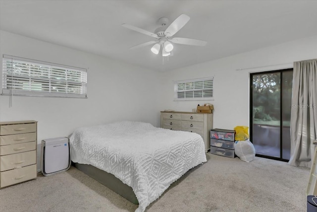 carpeted bedroom with access to exterior and ceiling fan