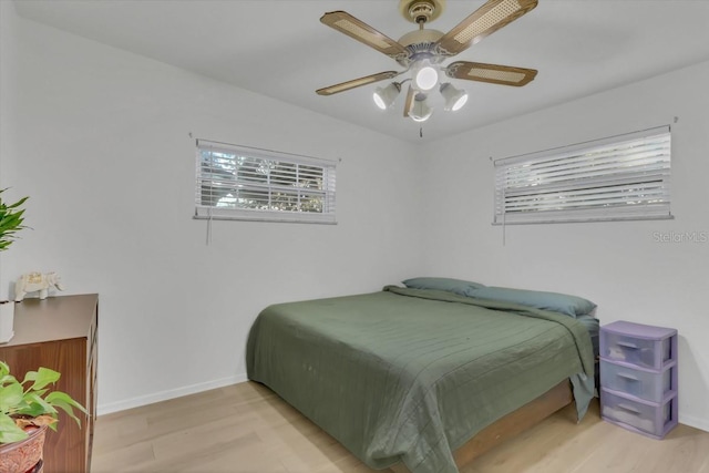 bedroom with light hardwood / wood-style flooring and ceiling fan