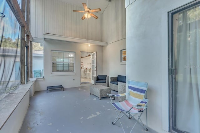 sunroom / solarium featuring ceiling fan