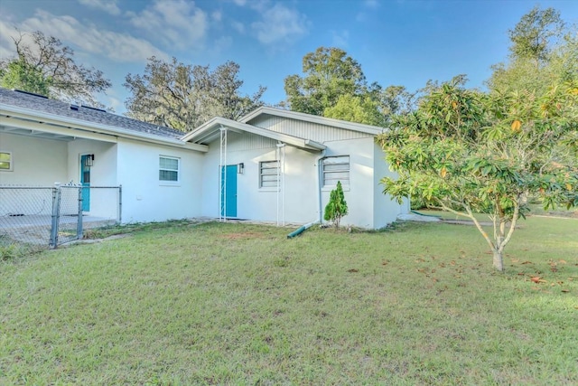 rear view of house with a yard