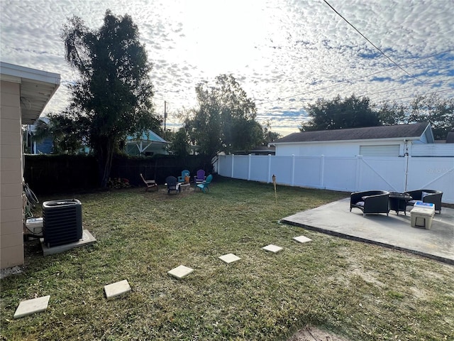 view of yard featuring central AC and a patio