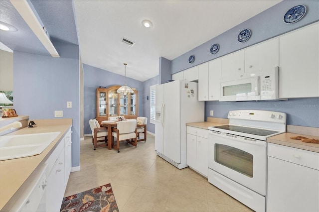 kitchen with sink, white cabinetry, light tile patterned floors, pendant lighting, and white appliances