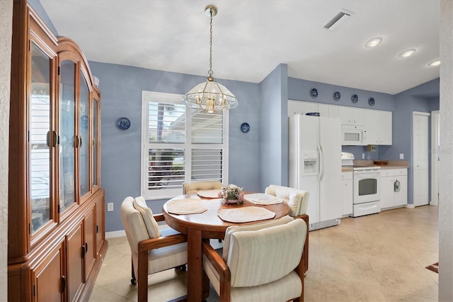 tiled dining area with a notable chandelier