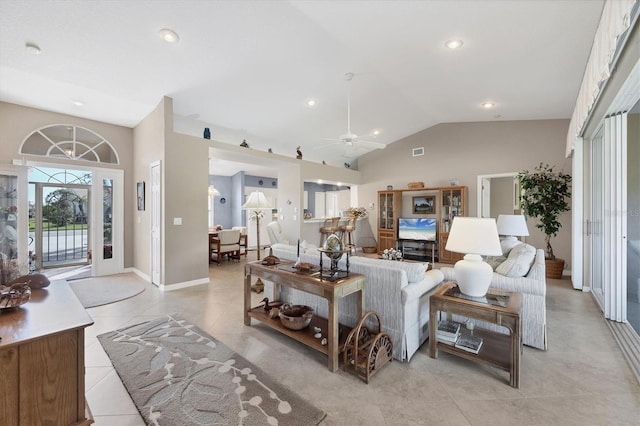 living room featuring vaulted ceiling, light tile patterned flooring, and ceiling fan