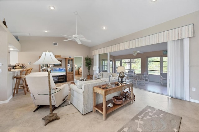 living room featuring vaulted ceiling, light tile patterned flooring, and ceiling fan