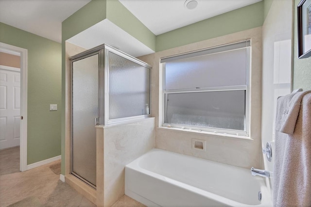 bathroom featuring tile patterned floors and independent shower and bath