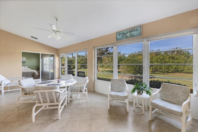 sunroom / solarium featuring ceiling fan and lofted ceiling