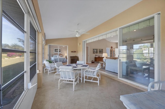 sunroom featuring lofted ceiling and ceiling fan