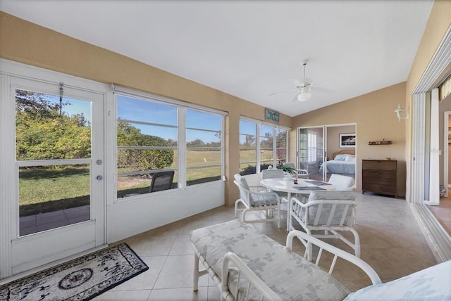 sunroom / solarium with ceiling fan and lofted ceiling