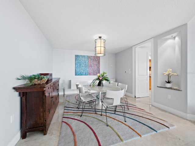 dining area featuring a textured ceiling