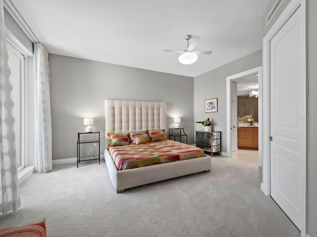 carpeted bedroom featuring connected bathroom and ceiling fan